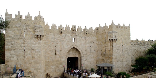 photo of Damascus Gate with people entering through.